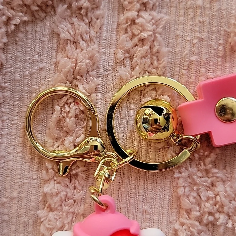 Hello Kitty, silicon keychain. NWOT. Metal hooks, pink and white 💗.